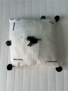 Handwoven White Decorative Pillow with Black Tassel Accents
